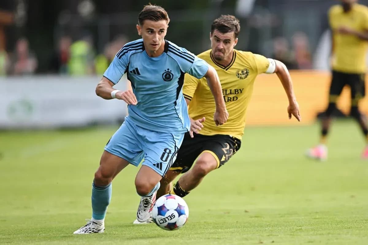 Slovan Bratislava player dribbling past Mjallby AIF opponent Slovan Bratislava player dribbling past Mjallby AIF opponent