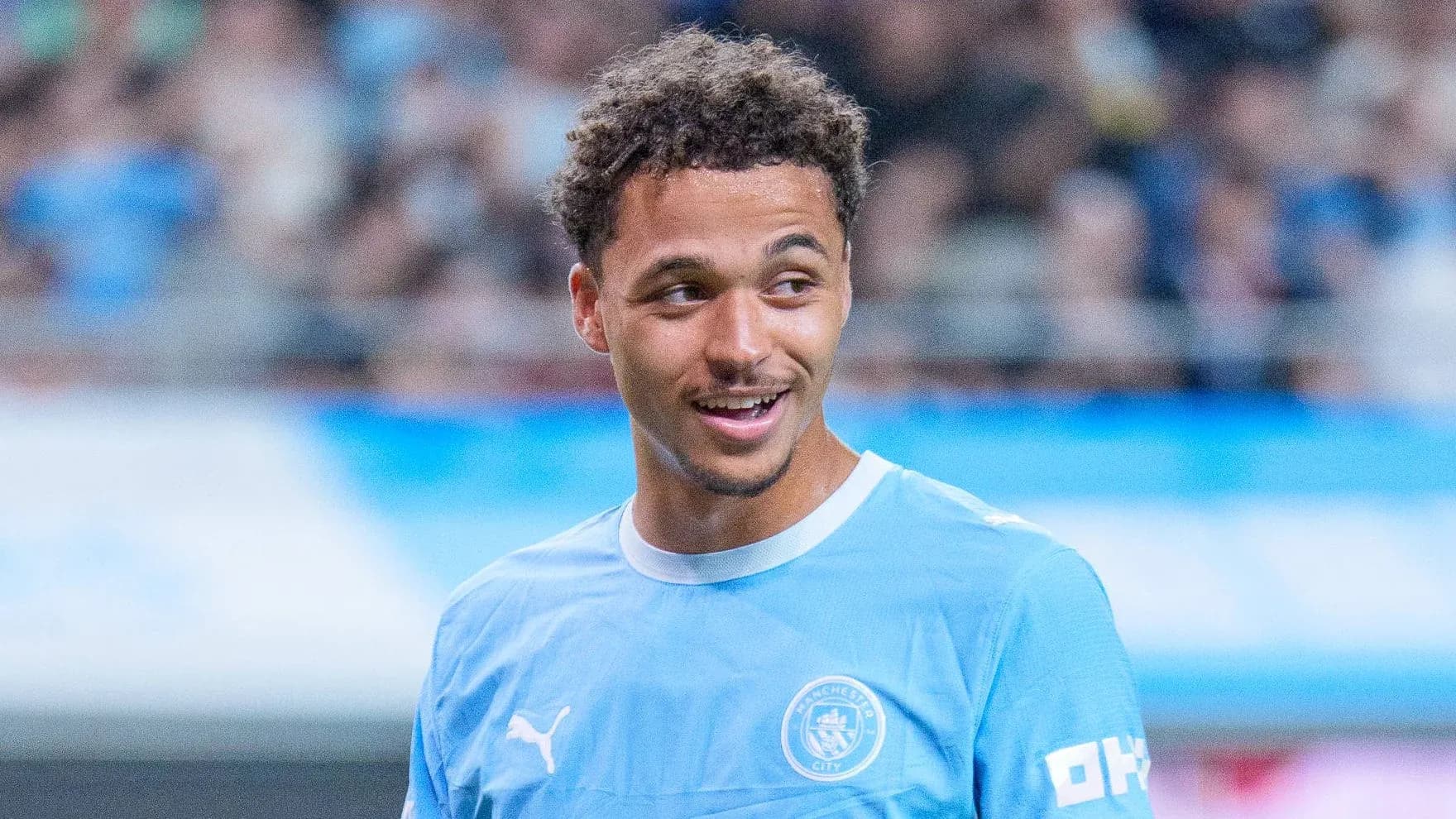 Player in Manchester City jersey smiling during warm-up Player in Manchester City jersey smiling during warm-up