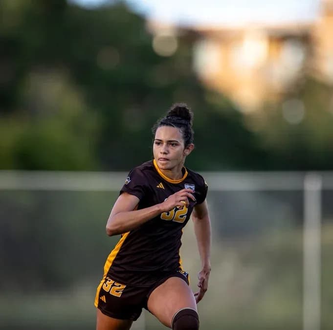 Female soccer player running on the field Female soccer player running on the field