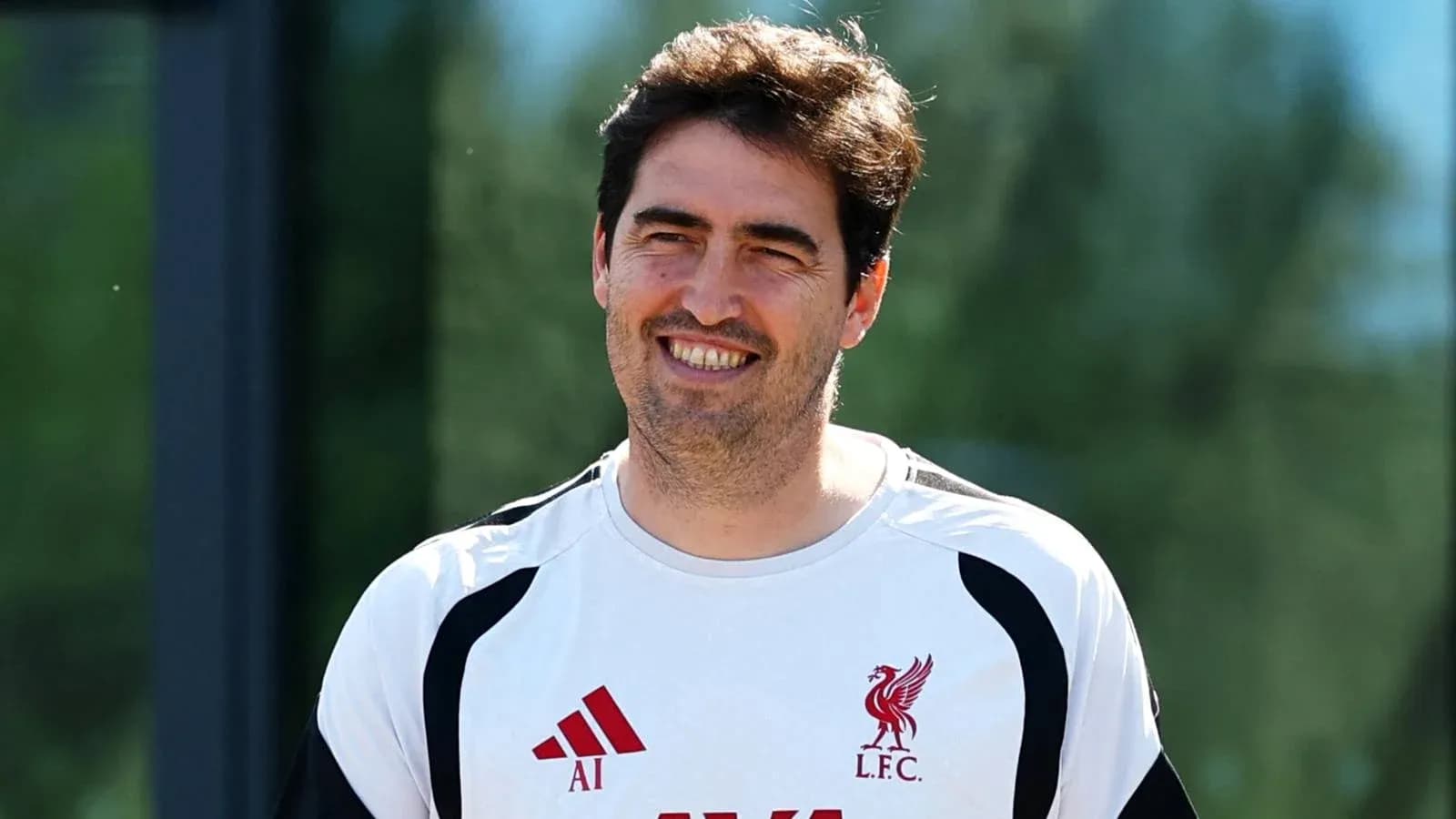 Coach wearing Liverpool training kit outdoors Coach wearing Liverpool training kit outdoors
