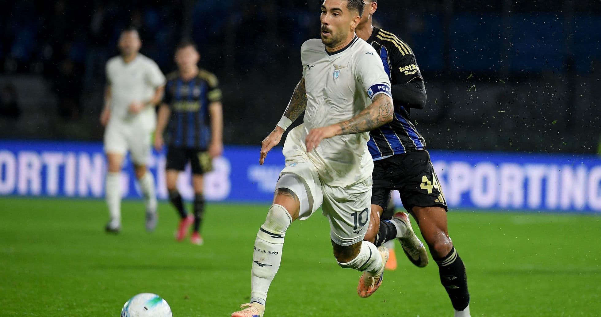 Lazio player dribbling against Pisa defender Lazio player dribbling against Pisa defender
