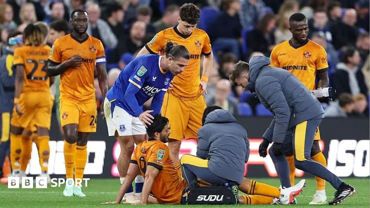 Players and medical staff attending to an injured player Players and medical staff attending to an injured player