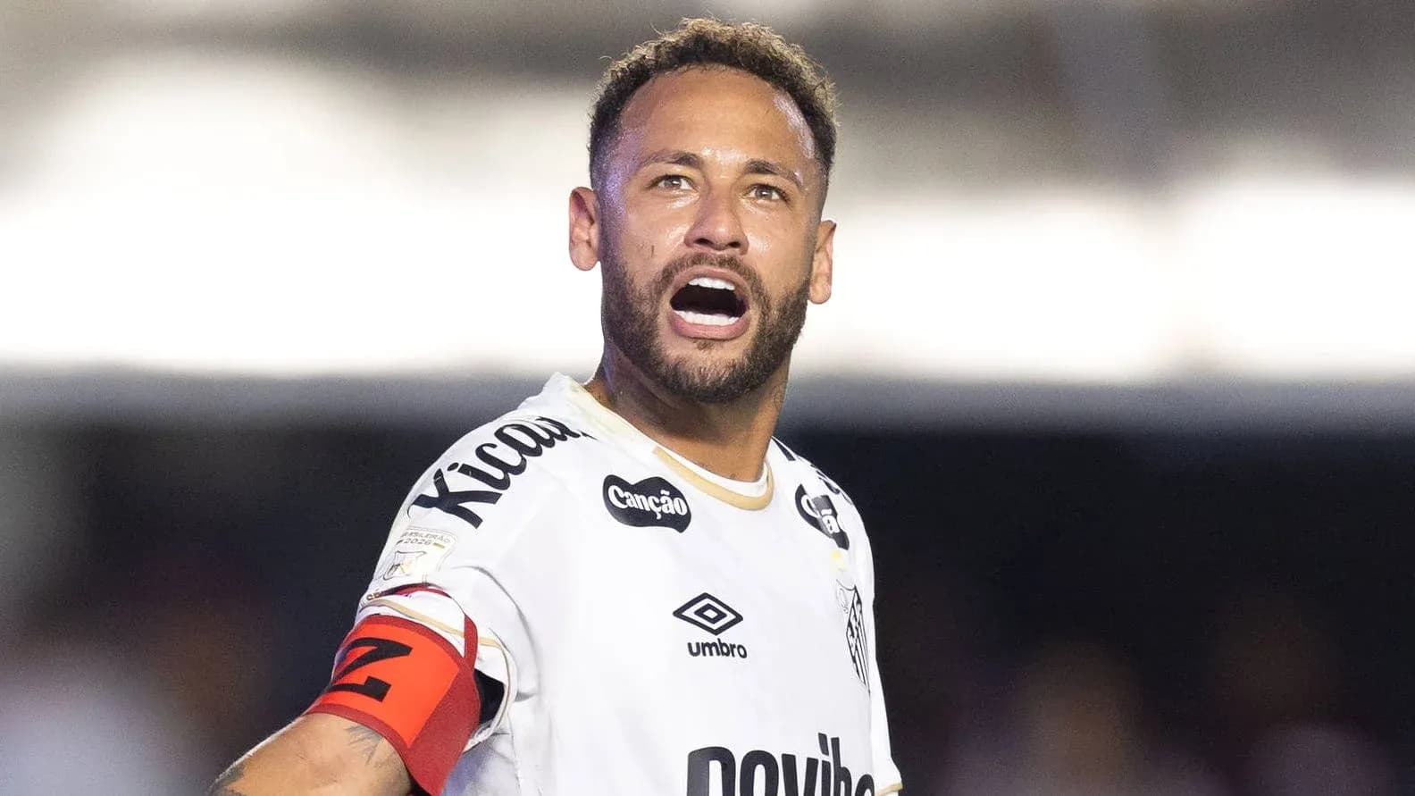 Player celebrating with arms raised on the field Player celebrating with arms raised on the field