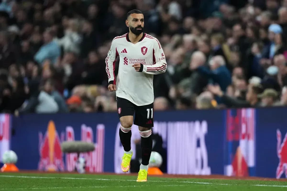 Player in Liverpool kit running on the pitch Player in Liverpool kit running on the pitch