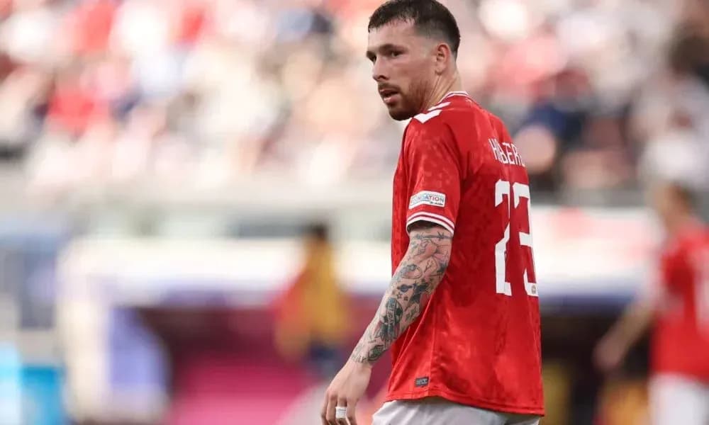 Player wearing red jersey on the field Player wearing red jersey on the field