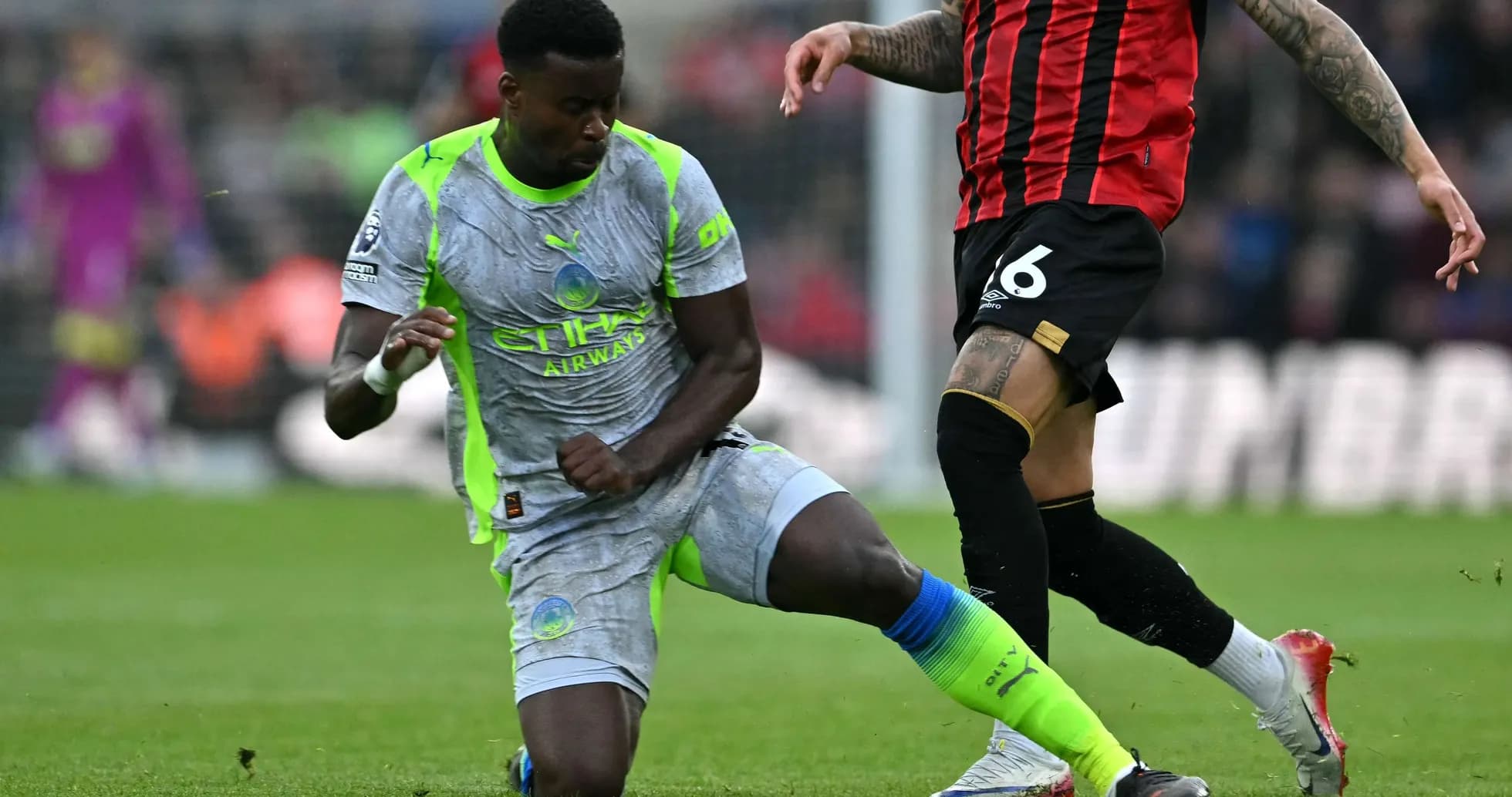 Manchester City player challenging Bournemouth opponent Manchester City player challenging Bournemouth opponent
