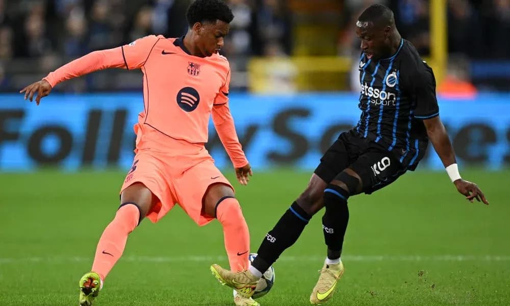 Two players competing for the ball on the field Two players competing for the ball on the field