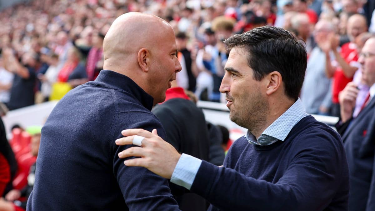Two coaches greeting each other before the match Two coaches greeting each other before the match