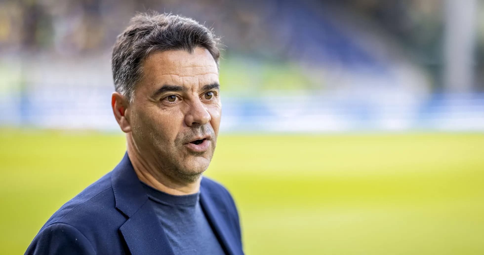 Coach speaking at a football match venue Coach speaking at a football match venue