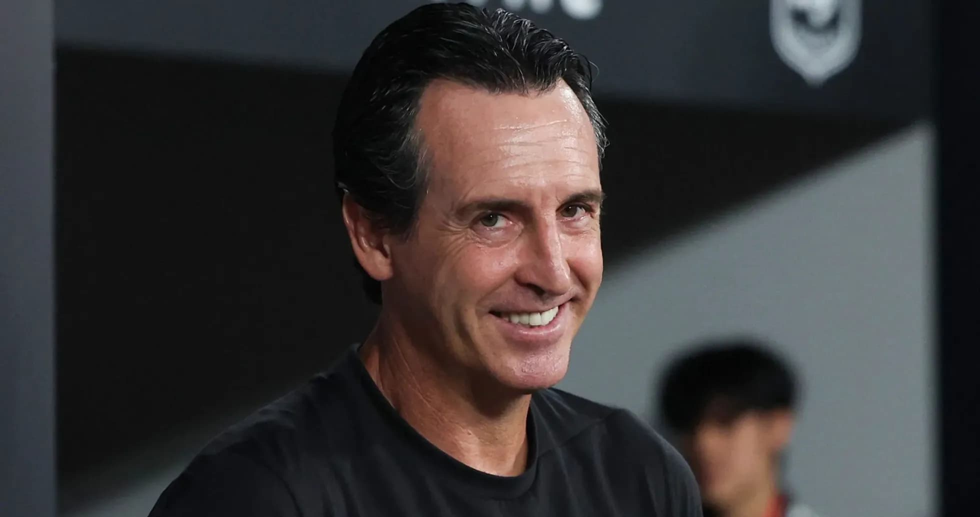 Coach smiling during a match in the dugout Coach smiling during a match in the dugout