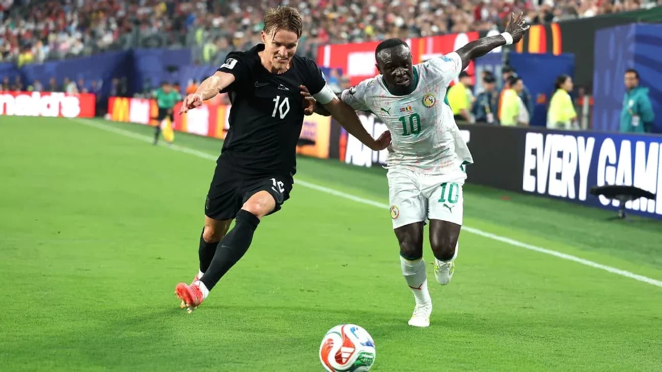 Two players contesting the ball on the field Two players contesting the ball on the field