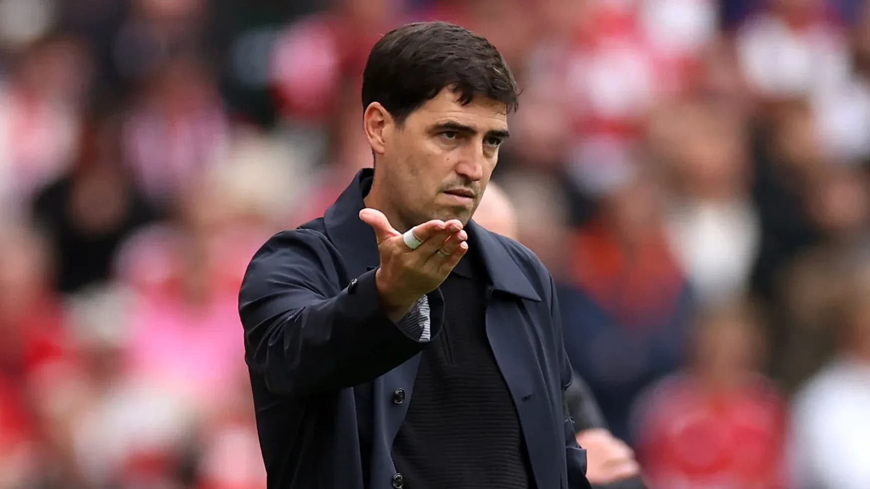 Coach gesturing during a match on the sideline Coach gesturing during a match on the sideline