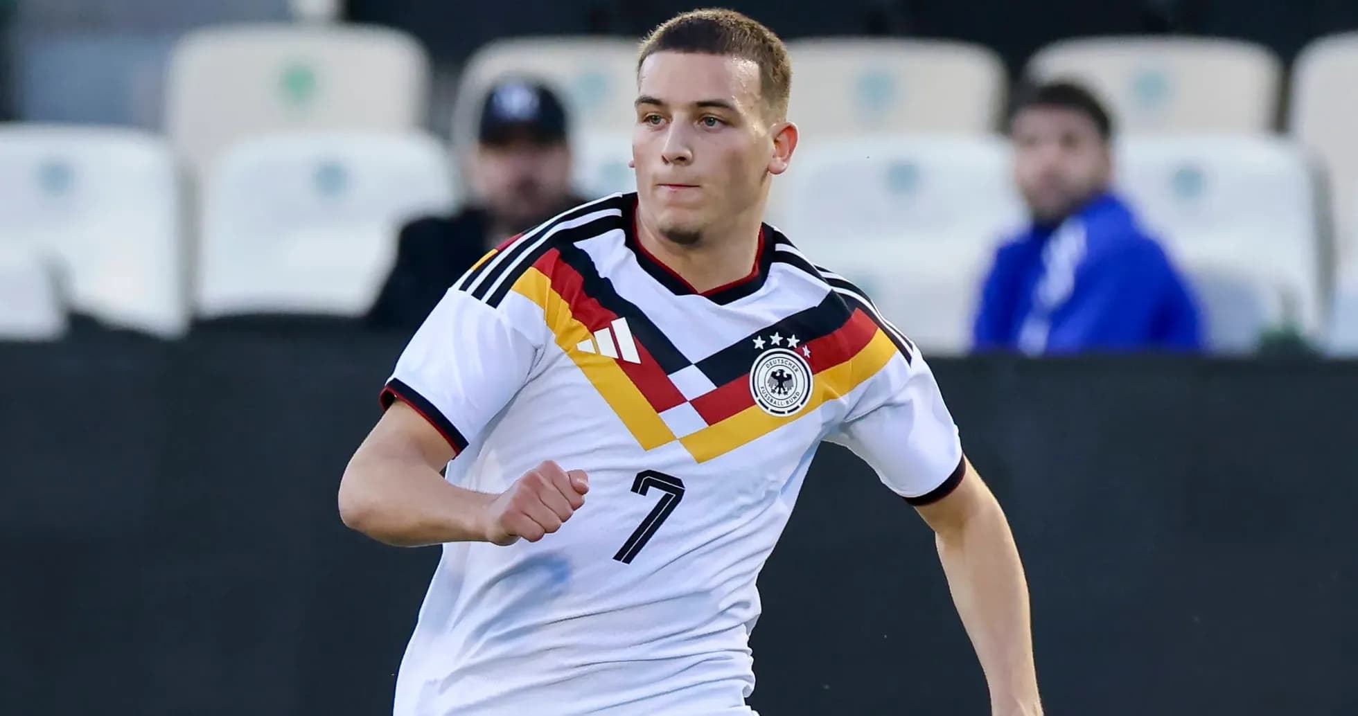Player in Germany kit running on the field Player in Germany kit running on the field