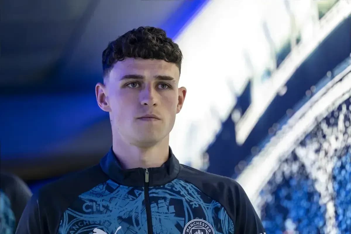 Player in Manchester City training gear standing indoors Player in Manchester City training gear standing indoors