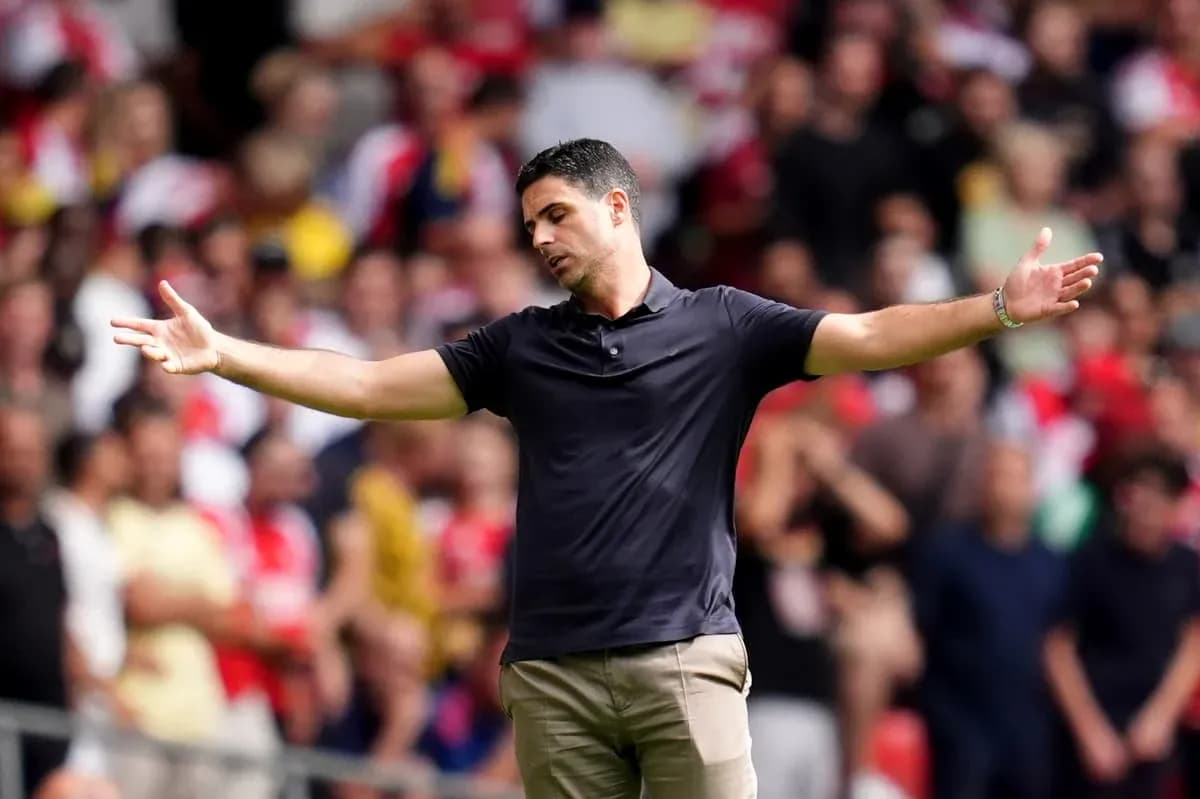 Manager gesturing during a match with fans in background Manager gesturing during a match with fans in background