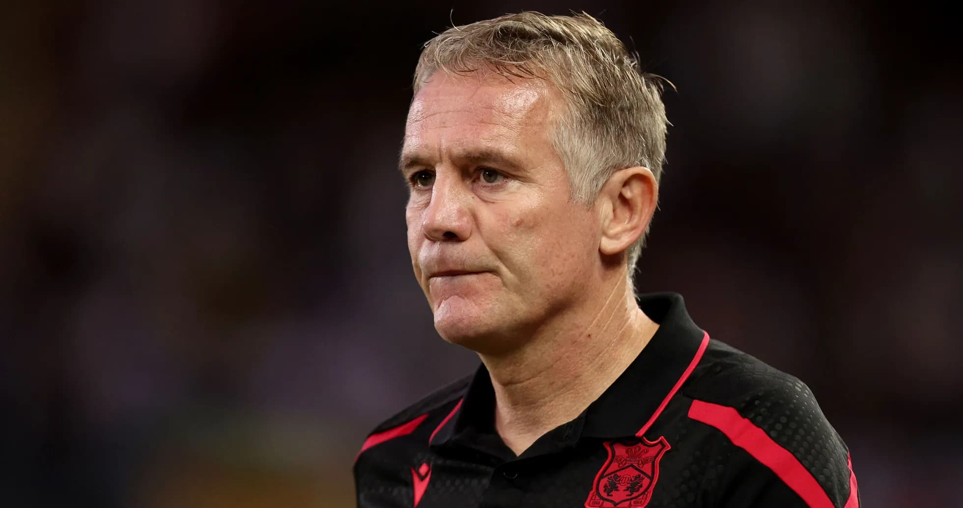 Coach wearing black shirt with red details Coach wearing black shirt with red details