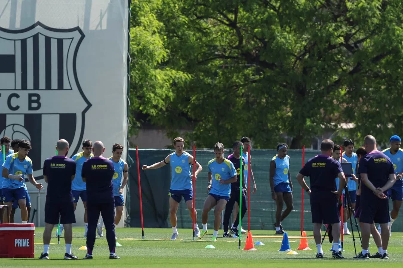 Barcelona players training on pitch with cones Barcelona players training on pitch with cones