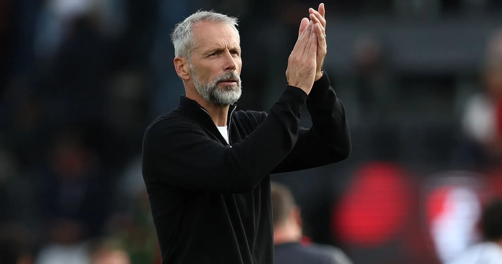 Coach applauding during a match or event Coach applauding during a match or event