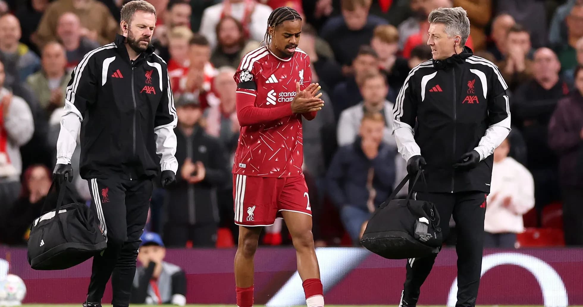 Liverpool player receiving medical attention from staff Liverpool player receiving medical attention from staff