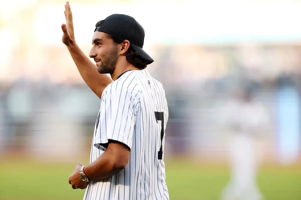 Man waving while wearing a striped baseball jersey Man waving while wearing a striped baseball jersey