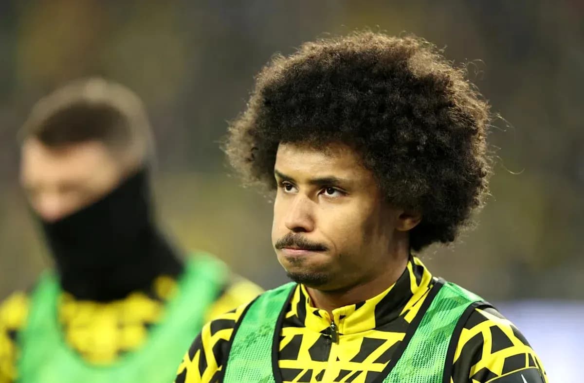 Player on bench wearing team colors and bib Player on bench wearing team colors and bib