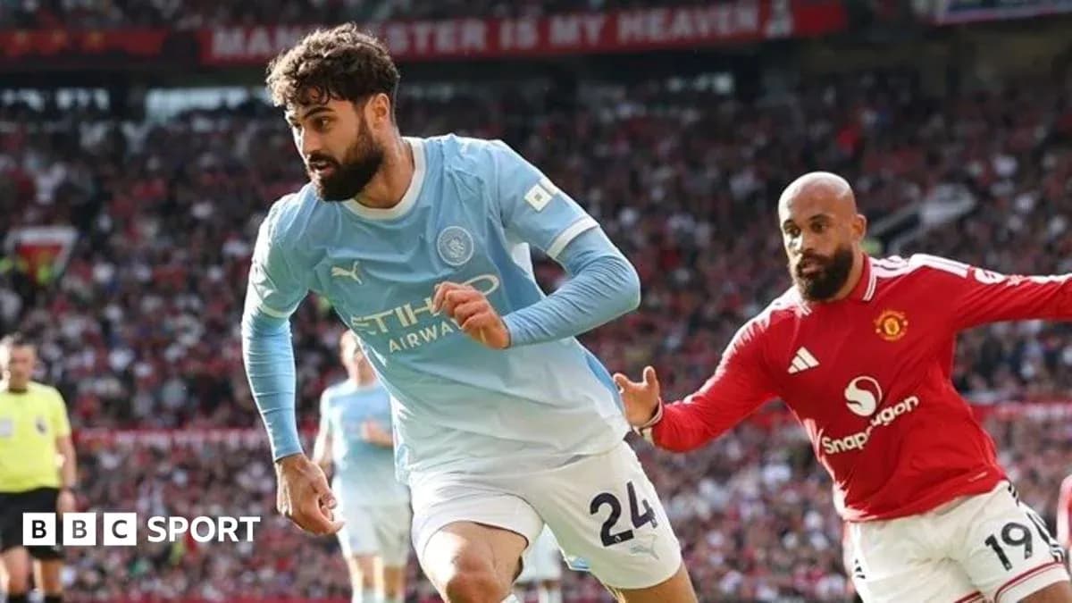 Manchester City player running with ball against Manchester United Manchester City player running with ball against Manchester United