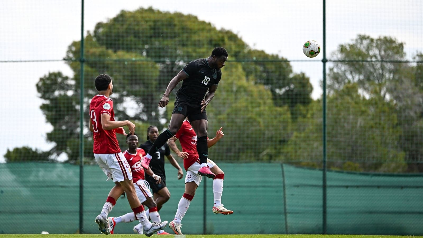 Player jumping to head the ball during training Player jumping to head the ball during training