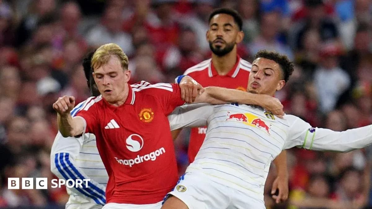 Two players in a tackle during a football match Two players in a tackle during a football match