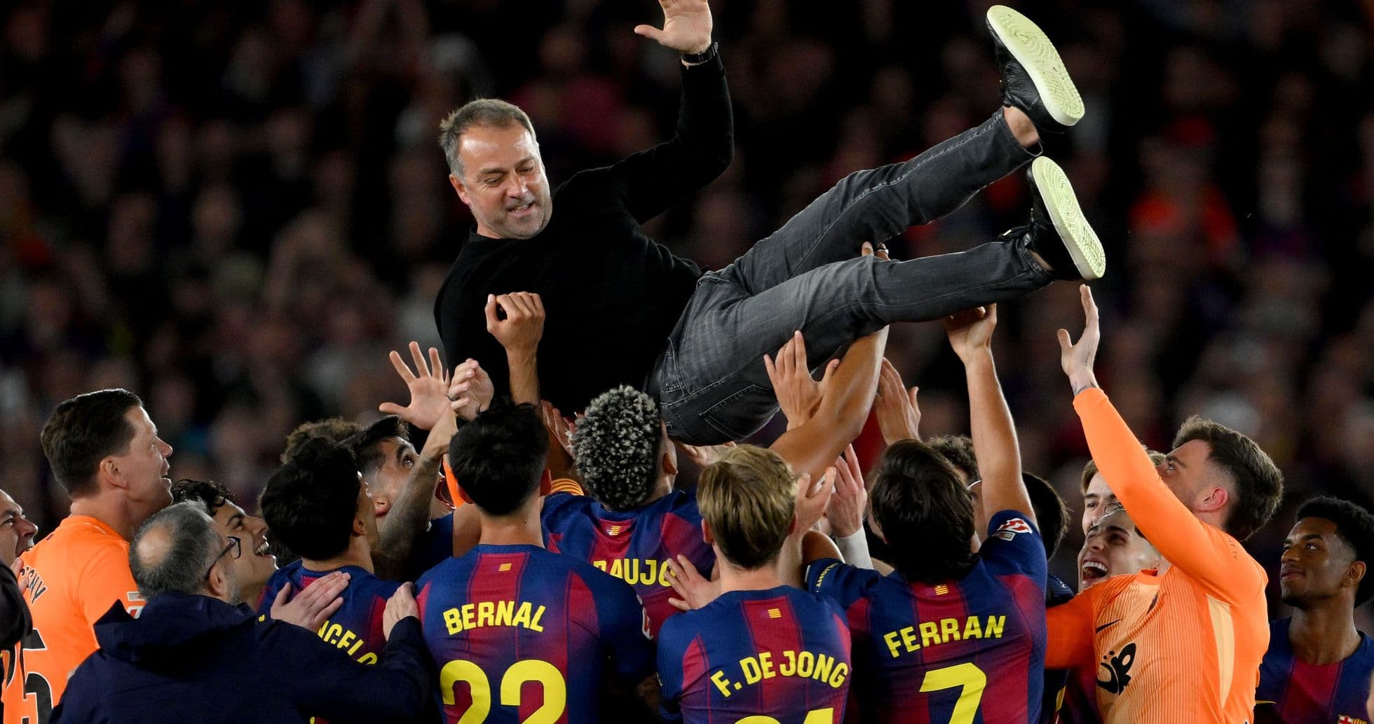 Team celebrating by lifting their coach in the air Team celebrating by lifting their coach in the air