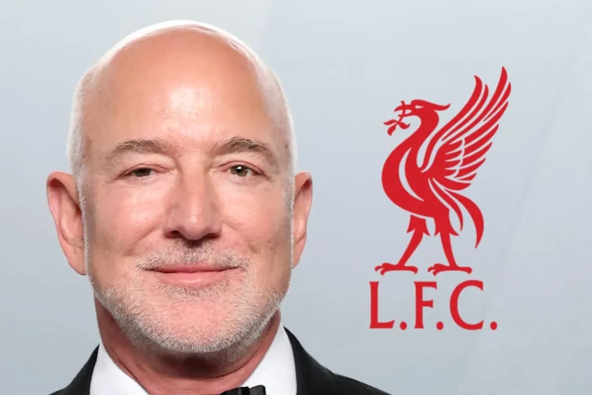 Man smiling with Liverpool FC logo in background Man smiling with Liverpool FC logo in background