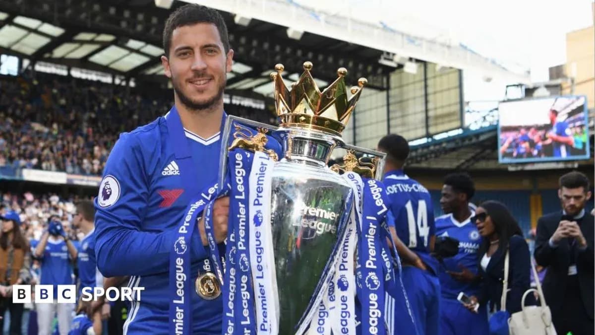 Player holding Premier League trophy at celebration event Player holding Premier League trophy at celebration event
