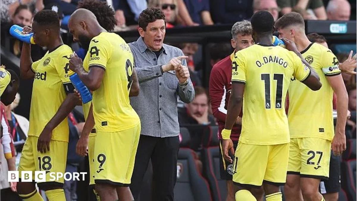 Manager instructing players during match substitution Manager instructing players during match substitution
