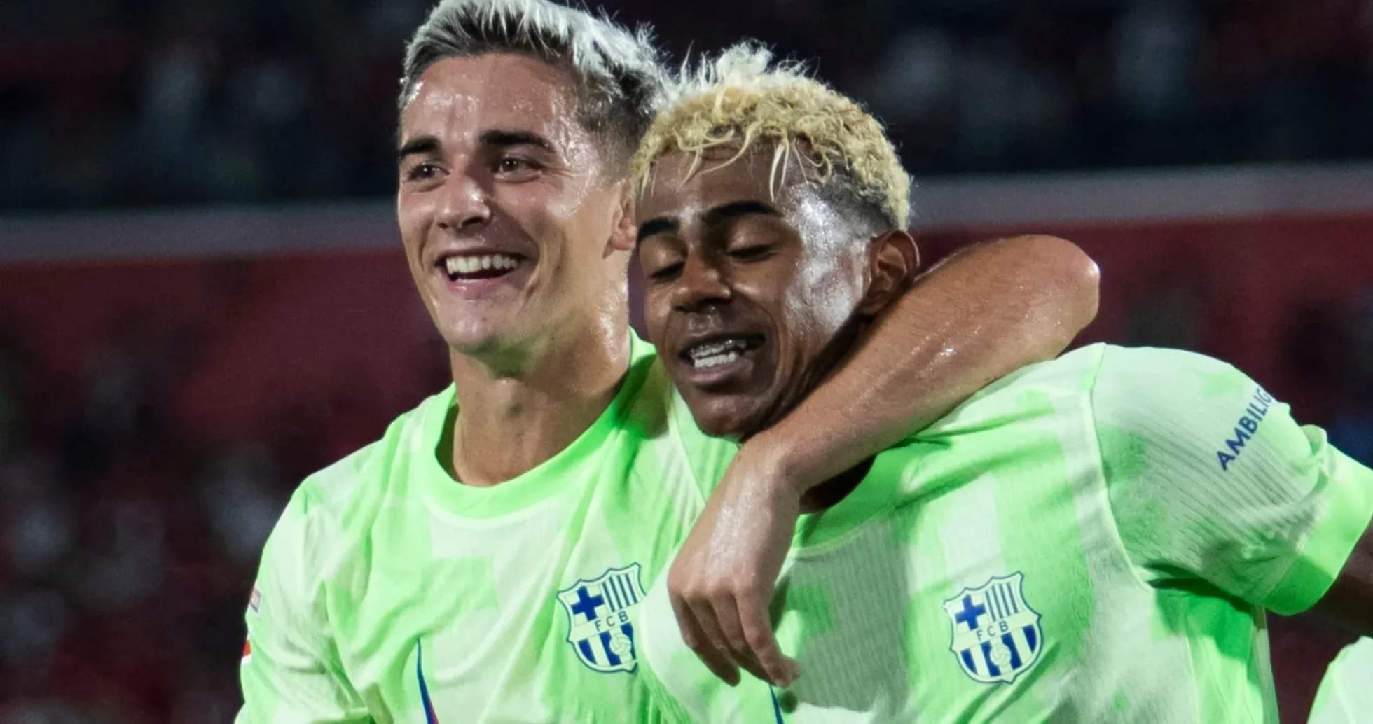 Two players celebrating together in green jerseys Two players celebrating together in green jerseys