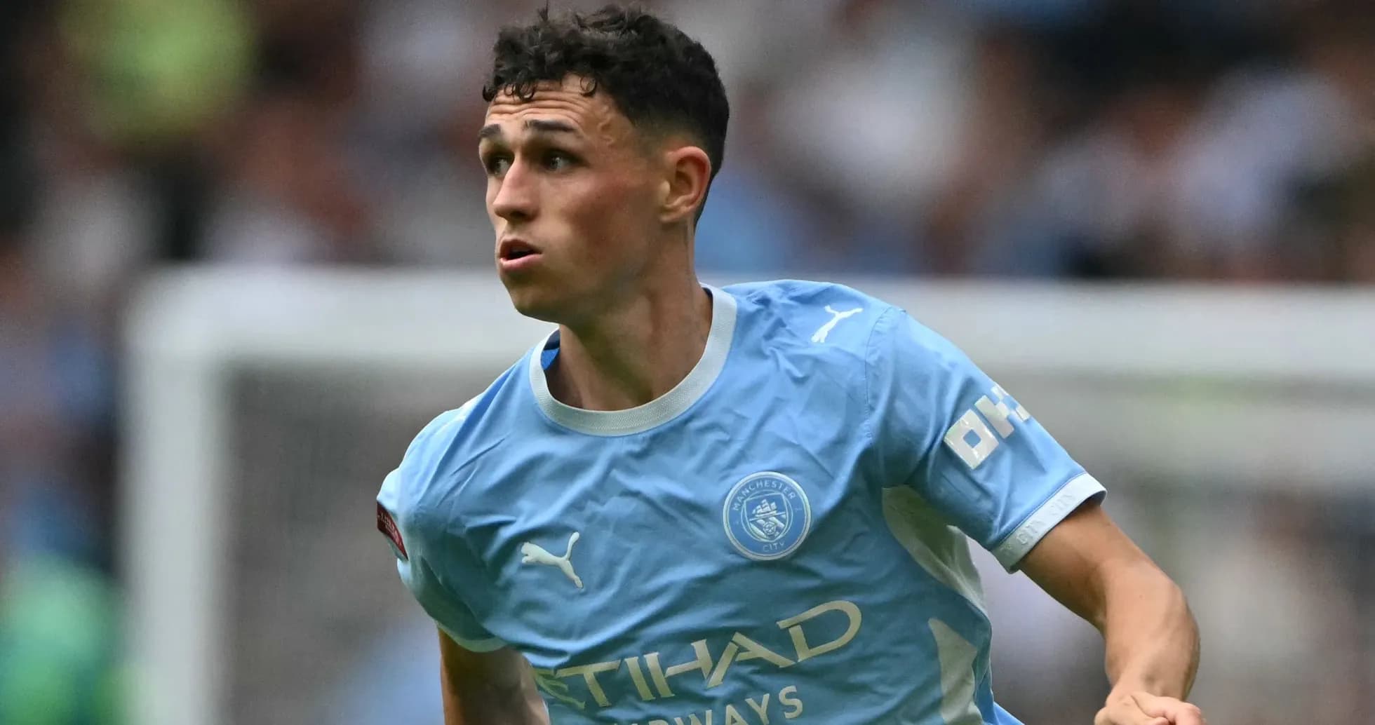 Phil Foden running during a Manchester City match Phil Foden running during a Manchester City match