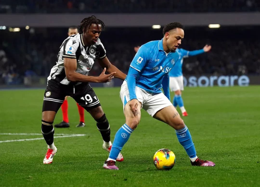 Napoli player dribbling against Udinese defender Napoli player dribbling against Udinese defender