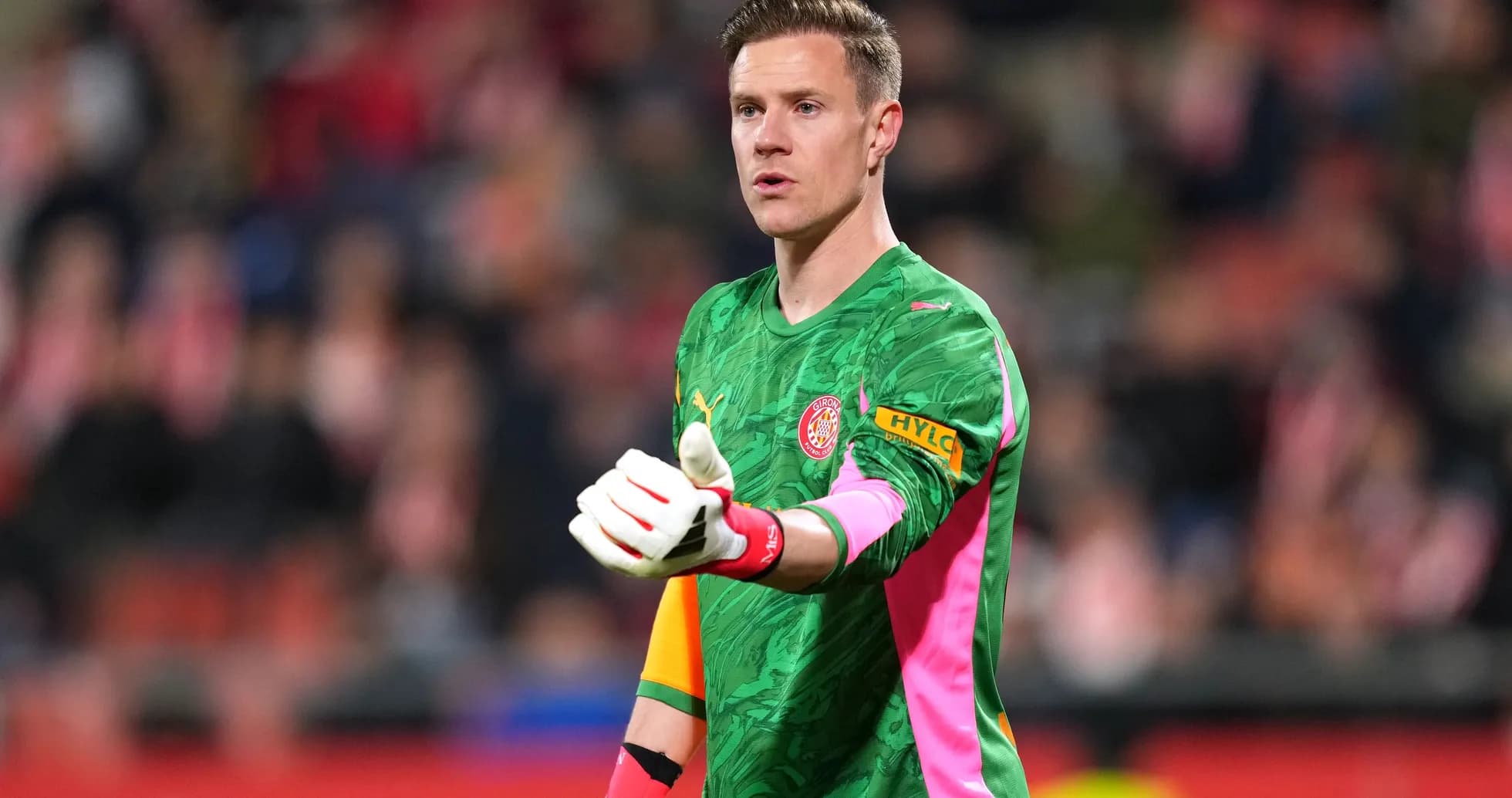 Goalkeeper gesturing during a match on field Goalkeeper gesturing during a match on field