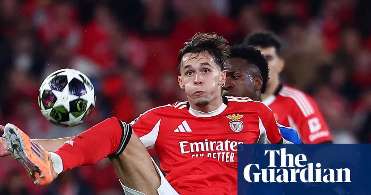 Benfica player in red jersey kicking ball during match Benfica player in red jersey kicking ball during match