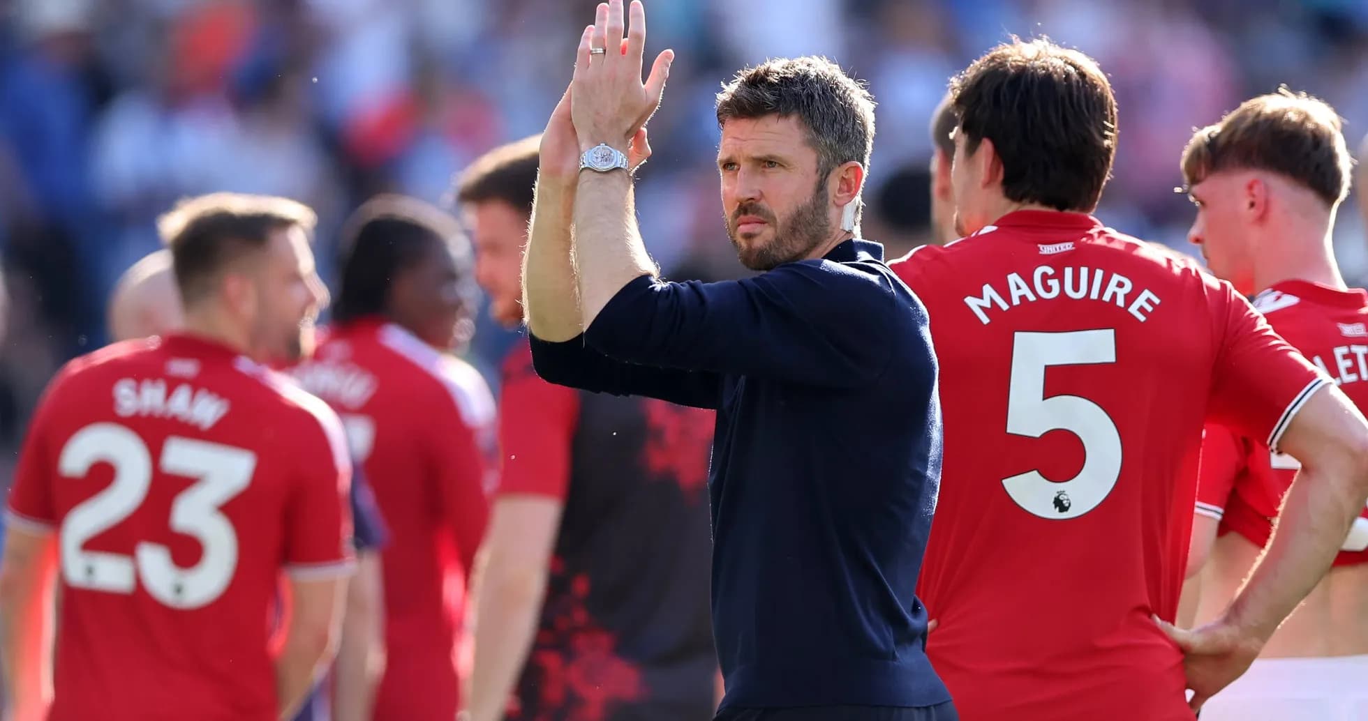 Manager applauding players after match on field Manager applauding players after match on field