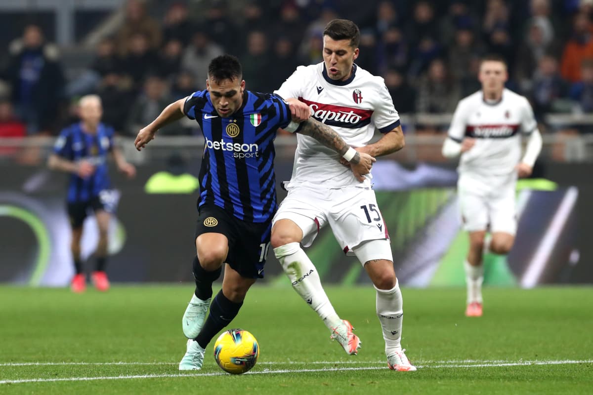 Bologna player challenges Inter player for the ball Bologna player challenges Inter player for the ball