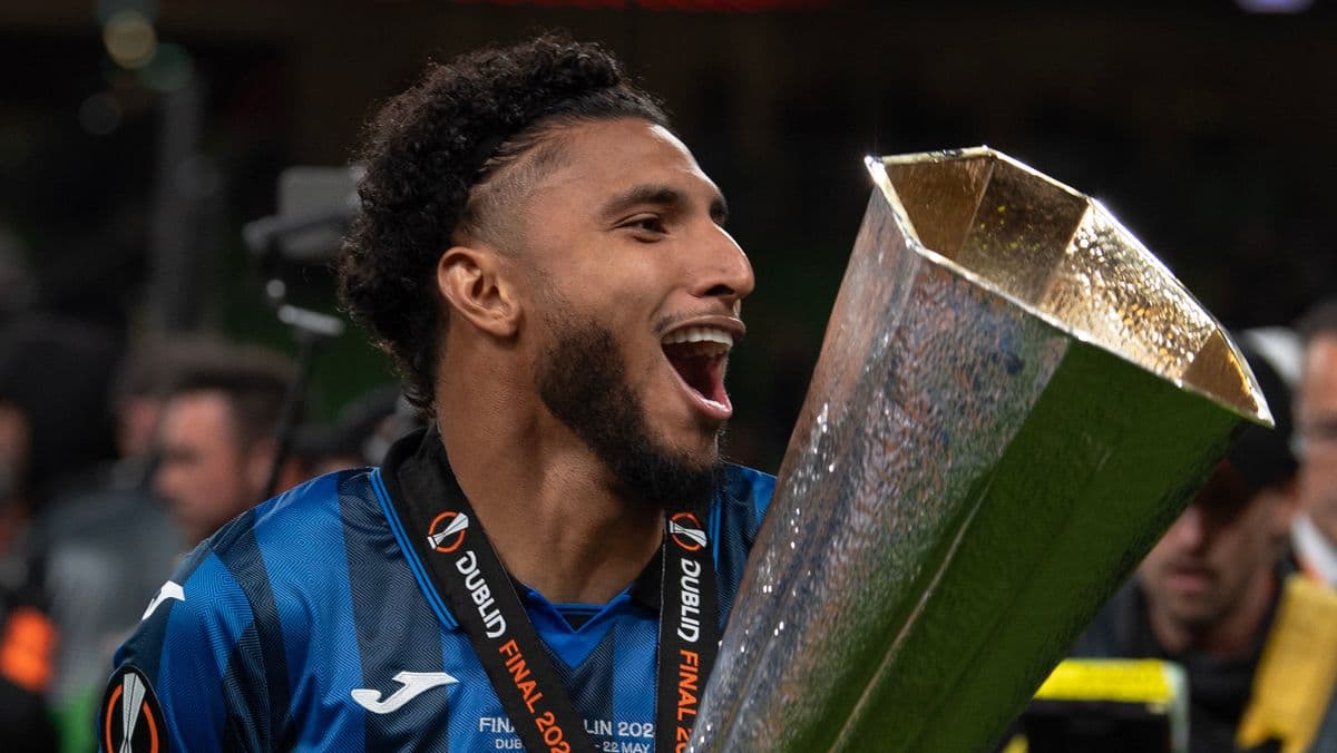 Player celebrating with trophy after winning match Player celebrating with trophy after winning match