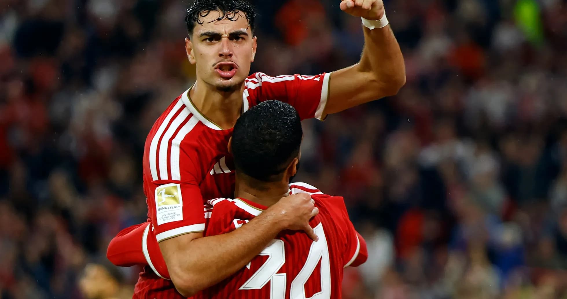 Player celebrating goal with teammate during match Player celebrating goal with teammate during match