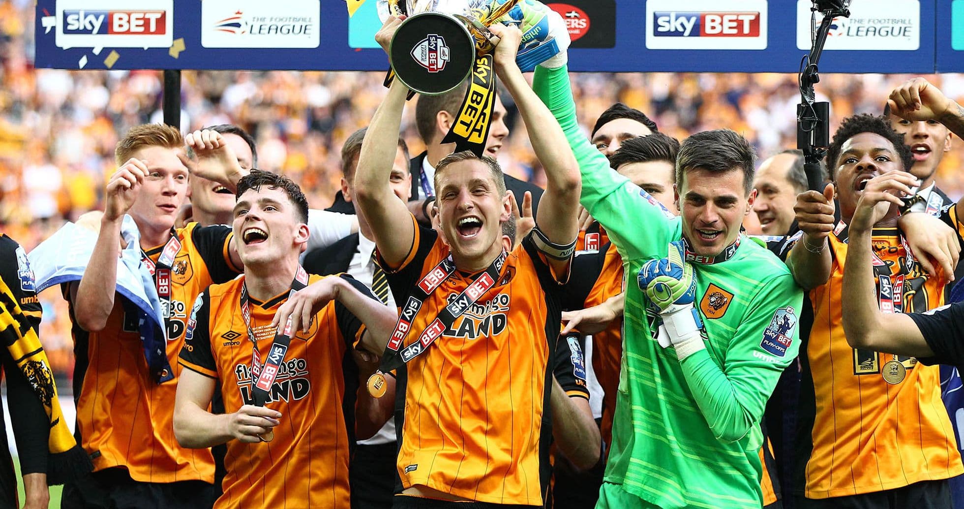 Team celebrating with trophy after winning championship Team celebrating with trophy after winning championship