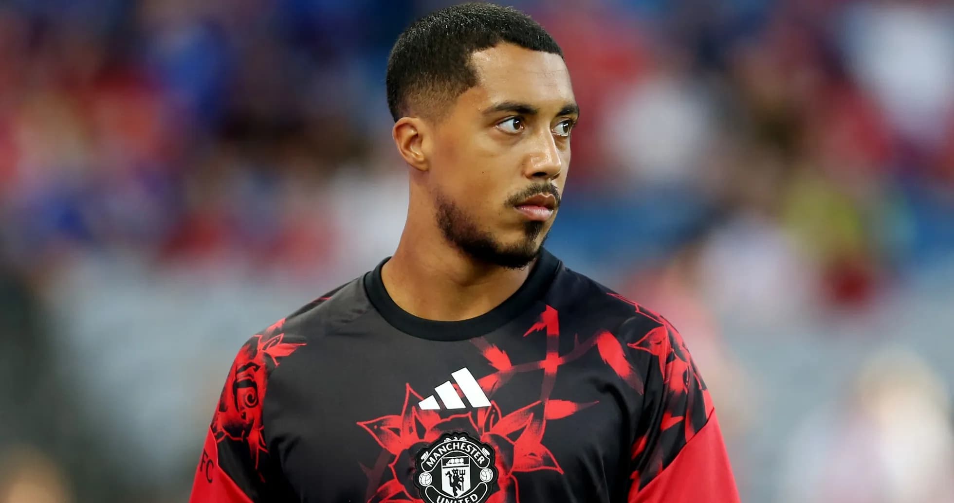 Player wearing Manchester United training kit on field Player wearing Manchester United training kit on field