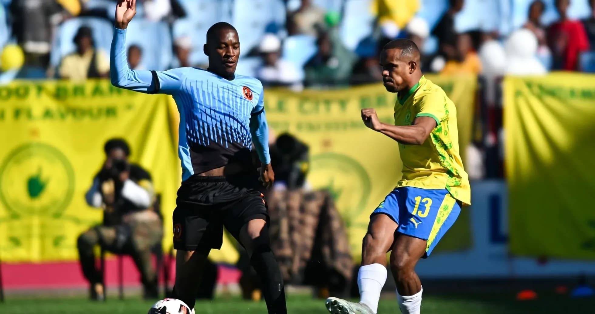 Two players competing for the ball during a match Two players competing for the ball during a match