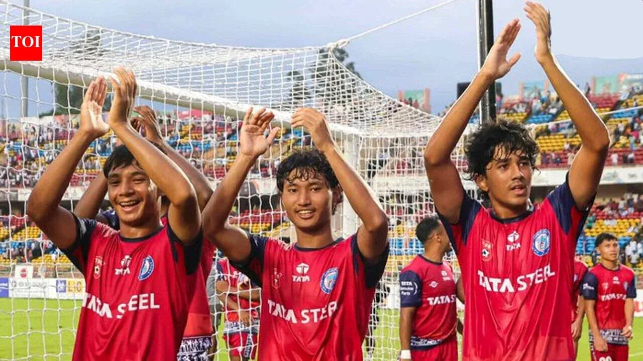 Three players celebrating in front of the goal net Three players celebrating in front of the goal net