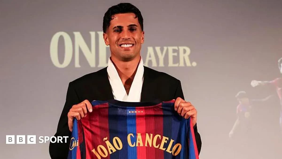 Player holding FC Barcelona jersey at presentation Player holding FC Barcelona jersey at presentation
