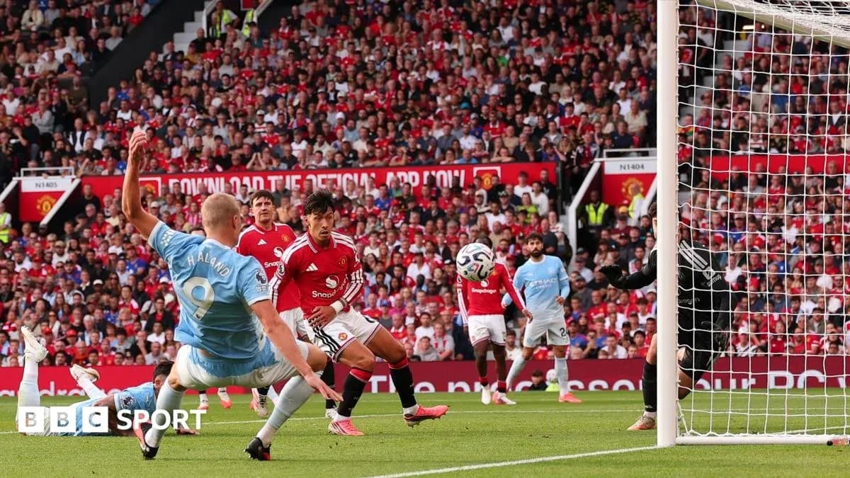 Player shooting towards goal during match at stadium Player shooting towards goal during match at stadium