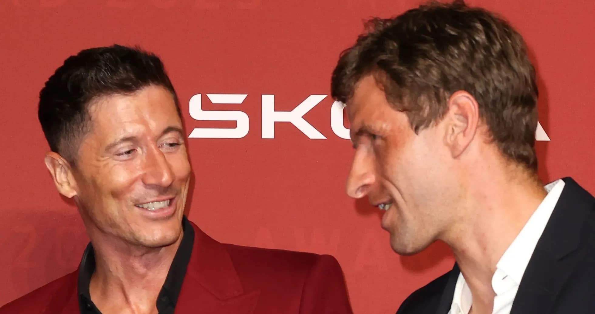 Two men smiling during an awards event Two men smiling during an awards event