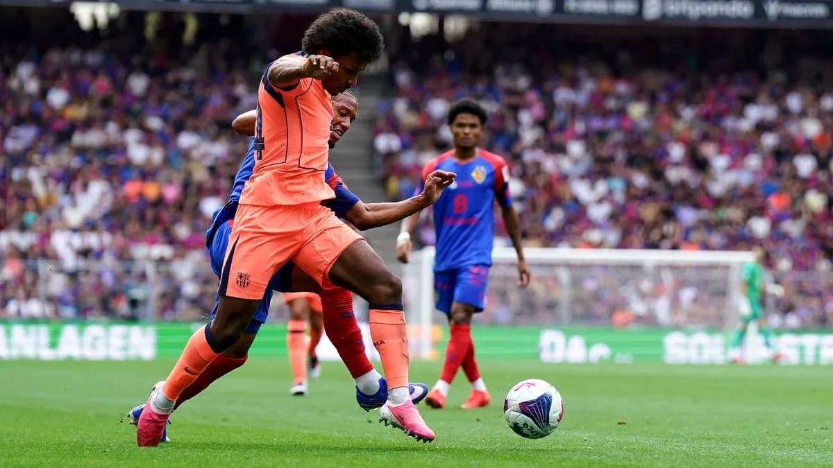 Player in orange jersey tackling opponent in blue jersey Player in orange jersey tackling opponent in blue jersey