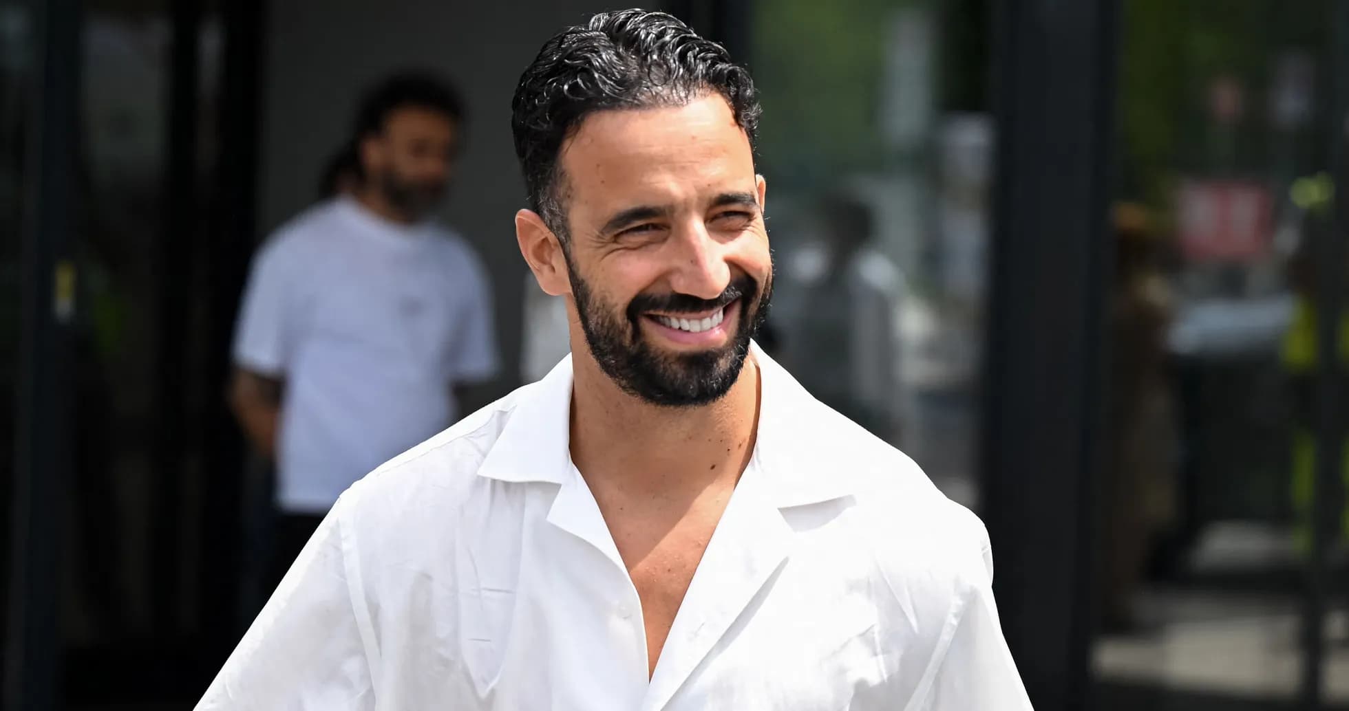 Smiling man in white shirt walking outside Smiling man in white shirt walking outside